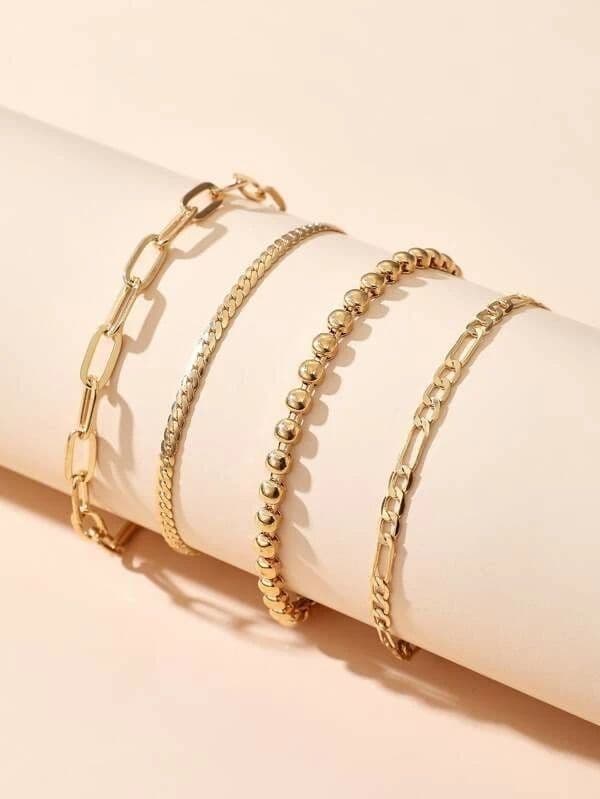 Gold drop earrings styled on smooth ivory marble background